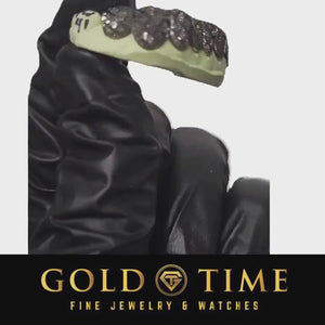 Video of a gloved hand holding the black trillion cut perm cut grillz on the mold