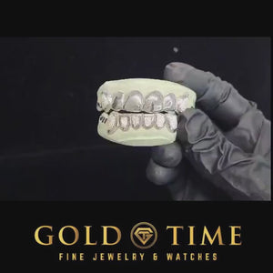 Video of a 12 piece diamond dust grillz set held in a gloved hand
