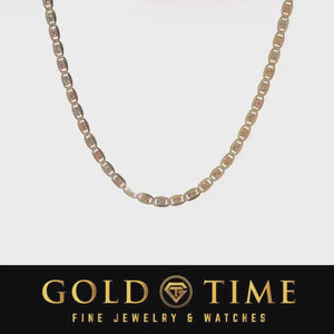 Video of a 14k gold Valentino link chain laid out on a light background