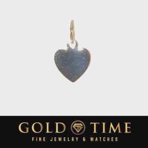 Video showing a small polished heart charm turning
