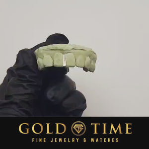 Video of a gloved hand turning the dental mold to show the single gap bar grill