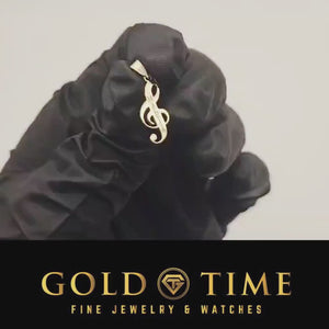Video of a yellow gold treble clef name pendant held in a gloved hand