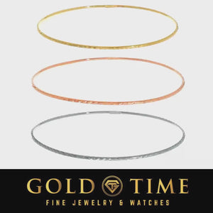 Video of yellow, rose, and white gold diamond-cut bangles catching the light