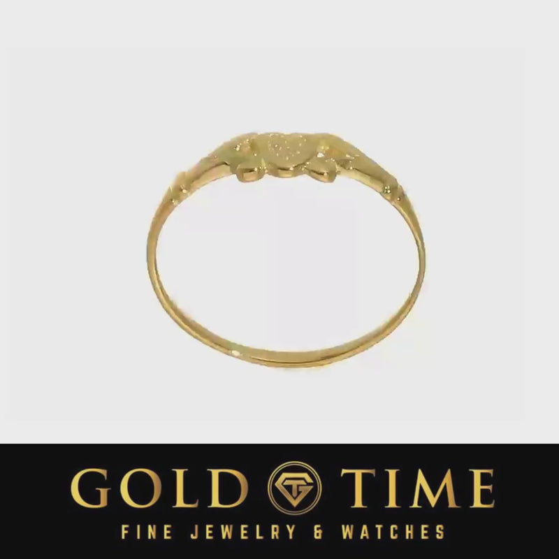 Video of the yellow gold heart and leaf ring turning on a light background