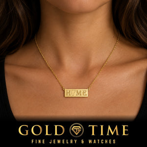 Woman wearing the dainty yellow gold HOME bar necklace with a state cutout in place of the O, Gold Time